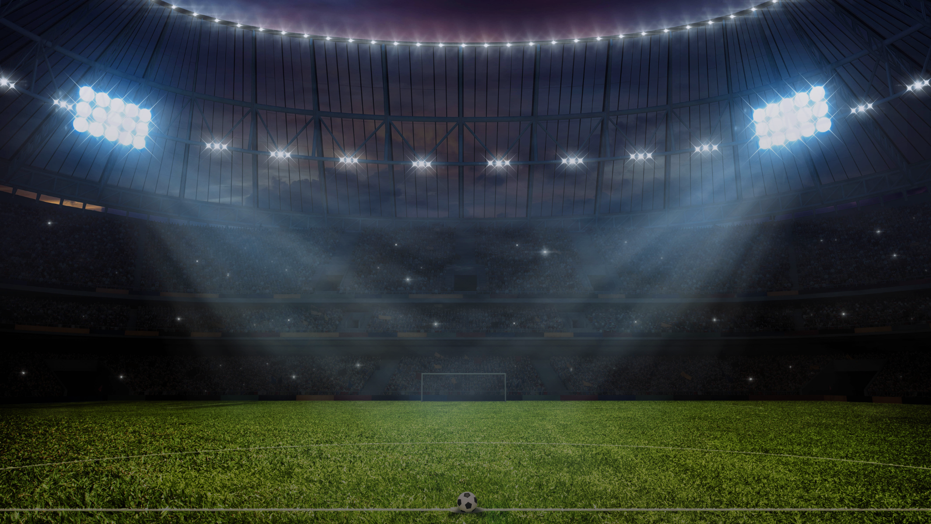 Ball in einem Stadion, er wird von Lichtern angestrahlt